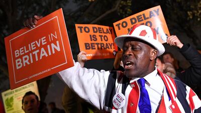 A pro-Brexit protester holds up a sign outside the Houses of Parliament in London. Reuters