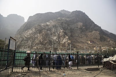 People stand in line to cross the border of Pakistan in Torkham, Nangarhar Province, Afghanistan, on Wednesday, November 1, 2017. Bloomberg