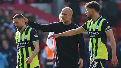 Manchester City manager Pep Guardiola consoles his players after losing to Nottingham Forest. AFP