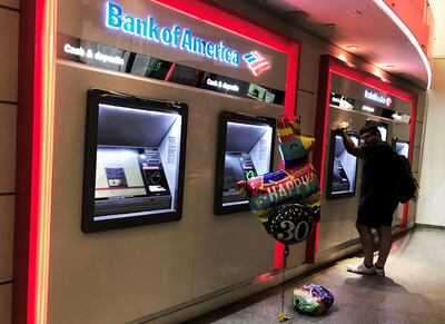 A man withdraws cash in Times Square, New York. Some consumers in the US have exhausted their savings, analysts say. Reuters
