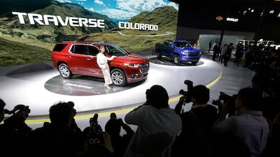Models pose with Chevrolet Colorado vehicles. Ahn Young-Joon / AP