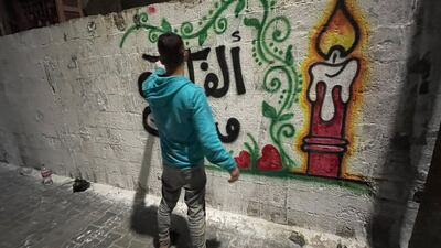 Calligrapher Abdullah Herz, 24, creating congratulatory artwork in Gaza City