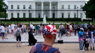 People gather on a section of Pennsylvania Avenue that was reopened to the public in front of the White House in Washington, DC.