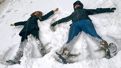 Some people took advantage of the snowstorm travel ban to have fun – Bianca Hillier, left, of Columbus, Ohio, and Eloise Pollard of London make snow angels on a normally busy stretch of Manhattan’s Tenth Avenue at West 34th Street in New York. AP Photo/Jennifer Peltz