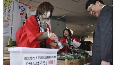 A Fukushima farmer uses a radiation detector on cucumbers to show the produce is safe during a trip to Tokyo last week.