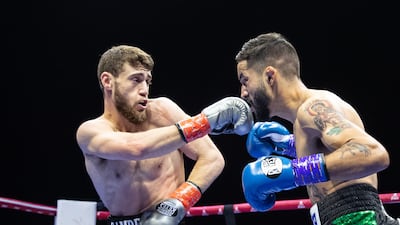 Dubai-based Bader Samreen, left, of Jordan, on his way to victory against Jose Paez Gonzales of Mexico in their lightweight bout.