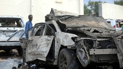A security officer from Doorbin Hotel assesses the debris after a suicide car explosion in front of the hotel in Mogadishu, Somalia. Feisal Omar / Reuters