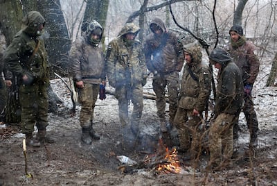 Ukraine soliders set a fire to get warm in the Luhansk region in March. AFP