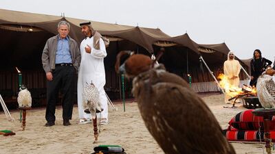 US president George W Bush talks with Sheikh Mohammed bin Zayed at a desert camp in January 2008, as Sheikh Mohammed bin Rashid and US secretary of state Condoleezza Rice stand by. Philip Cheung / The National