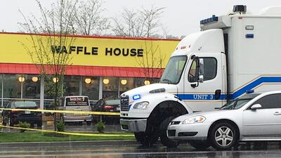Police vehicles parked outside a Waffle House restaurant in Nashville, Tennessee, where man with an assault rifle killed four people on April 22, 2018. Sheila Burke / AP Photo
