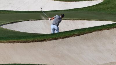 Jon Rahm of Spain takes a shot from a bunker at the DP World Tour Championship. AFP