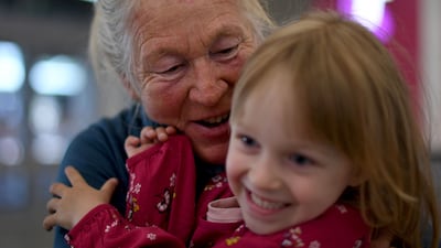 A woman hugs a child after being reunited at Sydney's international airport. AFP