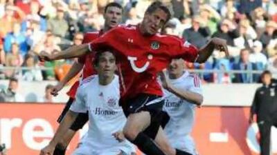 Hanover's Frank Fahrenhorst defends a Bayern attack.