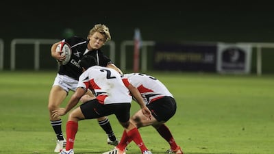 UAE’s Charlie Sargent tries to avoid a tackle by Singapore team members during the one-off Division 1 Test at The Sevens. The Singapore-born winger was making his debut. Sarah Dea / The National