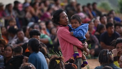 Displaced people, many of whose homes were burnt down, have sought refuge at a temporary shelter in a military camp. AFP
