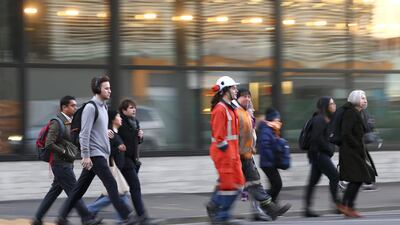 People make their way into the CBD during the first day under COVID-19 Alert Level 1 in Wellington, New Zealand. Getty Images