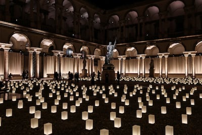 People walk by the statue of Napoleon as Mars the Peacemaker during Fashion Week in Milan, Italy. Reuters