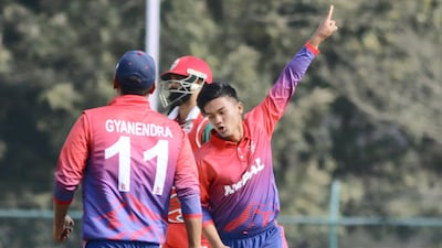 Kushal Malla of Nepal celebrates a wicket during the World Cup League Two match at Tribhuvan University. Subas Humagain for The National