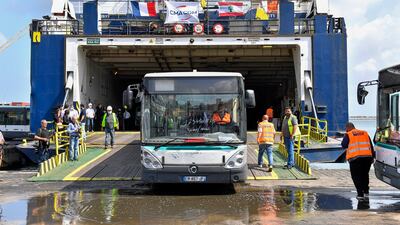 A bus donated by the French government to the Lebanese public transport sector is unloaded from a cargo ship at the Port of Beirut, Lebanon, 23 May 2022. The first batch consists of 50 buses donated to help develop Lebanon's public transport plan. EPA / WAEL HAMZEH