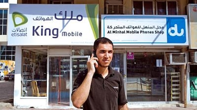 Abu Dhabi - July 28, 2008: Nezir Al Smadi, 26, talks on his cell phone in front of mobile phone shops on 11th street. ( Philip Cheung / The National )