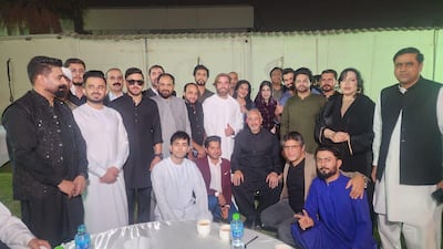 Faisal Niaz Tirmizi, Pakistan's ambassador to the UAE (seated centre in black), meets social media influencers and businessmen to spread the message warning people against travelling to the Emirates without authentic papers and funds to cover their stay. Photo: Pakistan Embassy in Abu Dhabi