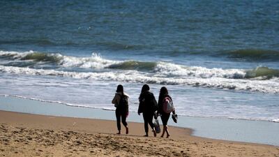 People walk on the beach in Bournemouth. AP Photo
