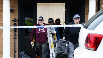 Police at the scene of arrests relating to the investigation. PA