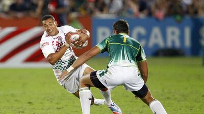 Marcus Watson of England, left, tries to avoid Chris Dry of South Africa during the Dubai Rugby Sevens World Series Cup semi-final between England and South Africa. Marcus is the eldest of the three Watson brothers who are making a name for themselves in rugby. Jake Badger for The National