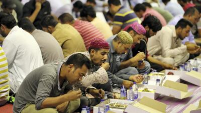 People breaking their fast on the first day of Ramadan at the Sheikh Zayed Grand Mosque in Abu Dhabi. Pawan Singh / The National