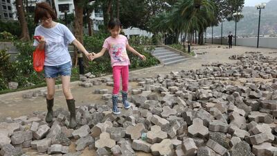 People walk on a broken pavement after Typhoon Mangkhut hit Hong Kong. Reuters