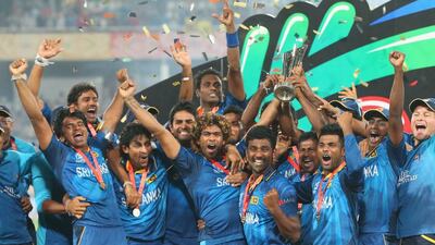 Lasith Malinga of Sri Lanka and his team celebrate with the trophy on the podium after winning the Final of the ICC World Twenty20 2014 in Bangladesh. Sri Lanka defeated India in the final. (Photo by Scott Barbour/Getty Images)
