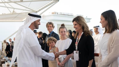 Sheikh Mohamed bin Zayed greets Maria Shriver, right, during a Sea Palace barza.