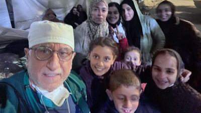 Dr Naji takes a selfie with young people in tents in Gaza.