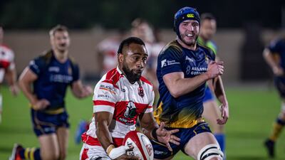 Sakiusa Naisau, left, makes a break for Dubai Tigers in their win over Doha in the West Asia Premiership at the Tigers Park on Friday. All images Antonie Robertson / The National