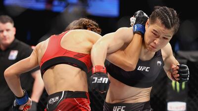 Zhang Weili and Joanna Jedrzejcyk exchange strikes during their fight at UFC 275. Getty