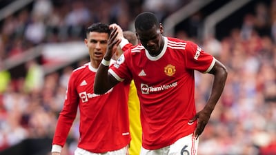Manchester United's Paul Pogba, right, reacts after a clash of heads during the Premier League match against Norwich at Old Trafford in April 2022. PA