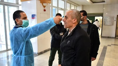 A Lebanese medic takes the temperature of a suspected coronavirus case at Rafiq Hariri University Hospital in Beirut where coronavirus COVID-19 patients are being treated. AFP