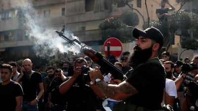 A supporter of the Shiite Amal group fires into the air during funeral processions in the southern Beirut suburb of Dahiyeh. AP