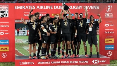 New Zealand celebrate with the trophy after winning the 2018 Dubai Rugby Sevens. AFP