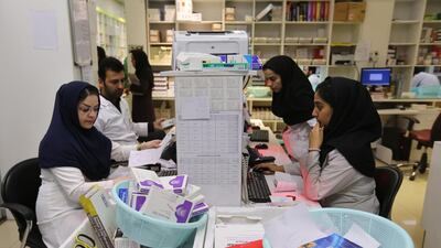 Iranian medical staff work at the state-run pharmacy in Tehran, amid reports of scarce medicine supplies in the country. AFP