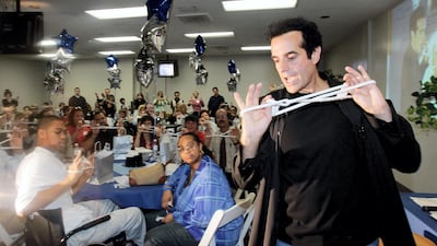 Entertainer David Copperfield performs magic tricks in front of an audience of magicians, physical therapists and patients at the Centinela Freeman Regional Medical Center in Inglewood, California in 2007. AFP