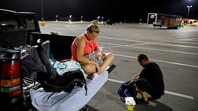 Lorrainda Smith sits with Luke on the back of a pick-up truck. AP Photo