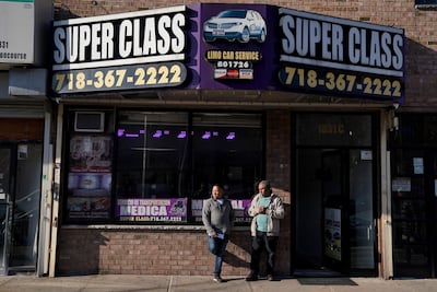 Driver Antonio Rosario, left, talks to Roberto Francis in front of Super Class Radio Dispatch in the Bronx borough of New York. Livery cab companies play an important role in some low-income neighbourhoods in the city with no yellow cabs and sometimes sparse public transport. AP