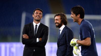 Paolo Maldini, left, Andrea Pirlo and Gianluigi Buffon stand during the “Match for Peace” at Rome’s Olympic Stadium on September 1, 2014. Filippo Monteforte / AFP