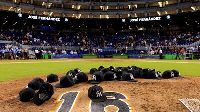 Miami players leave their hats on the pitching mound after leaving the field. Rob Foldy/Getty Images