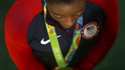 Simone Biles of USA poses with her gold medal after winning the women’s gymnastics individual all-around title at the 2016 Rio Olympics at Rio Olympic Arena on August 11, 2016 in Rio de Janeiro, Brazil. Kai Pfaffenbach / Reuters