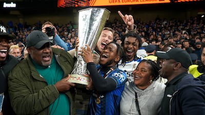 Ademola Lookman with father Felix (left) and family members as they celebrate with the trophy. PA