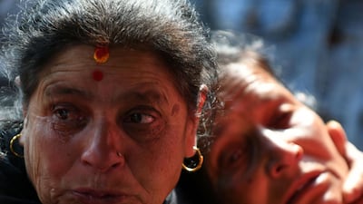 Family members of plane crash victims react outside a morgue at the Teaching Hospital in Kathmandu on March 13, 2018, a day after the deadly crash of a US-Bangla Airlines plane at the international airport. Prakesh Mathema / AFP