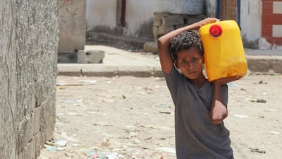 A Yemeni boy returns home after filling his jerrycan with water amid a severe shortage of water in southern Yemen's capital Aden, on April 30. Saleh Al-Obeidi / AFP