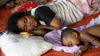 A Rohingya woman sleeps with her son at a temporary shelter in Kuala Langsa, Aceh, Indonesia on May 17. Hotli Simanjuntak/EPA